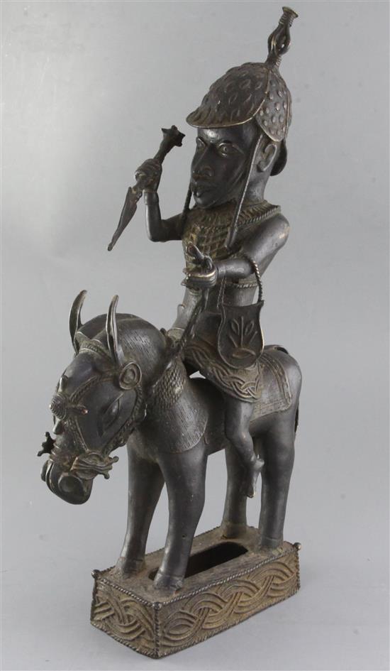 A large Benin bronze figure of a horse and rider, representing an armed messenger of King Oba, 57cm